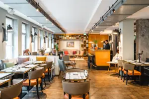 Lounge area at the HENRI Hotel Hamburg Lounge area with tables and chairs.