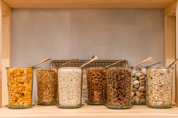 Cereals A group of glass containers with spoons.