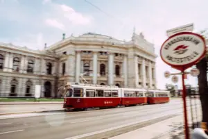 Vienna tramway A red and white tram carriage on a road.