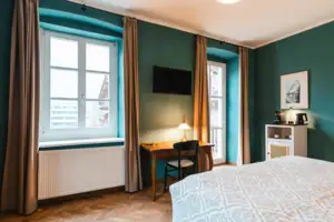 Room view A room with a bed and a desk.