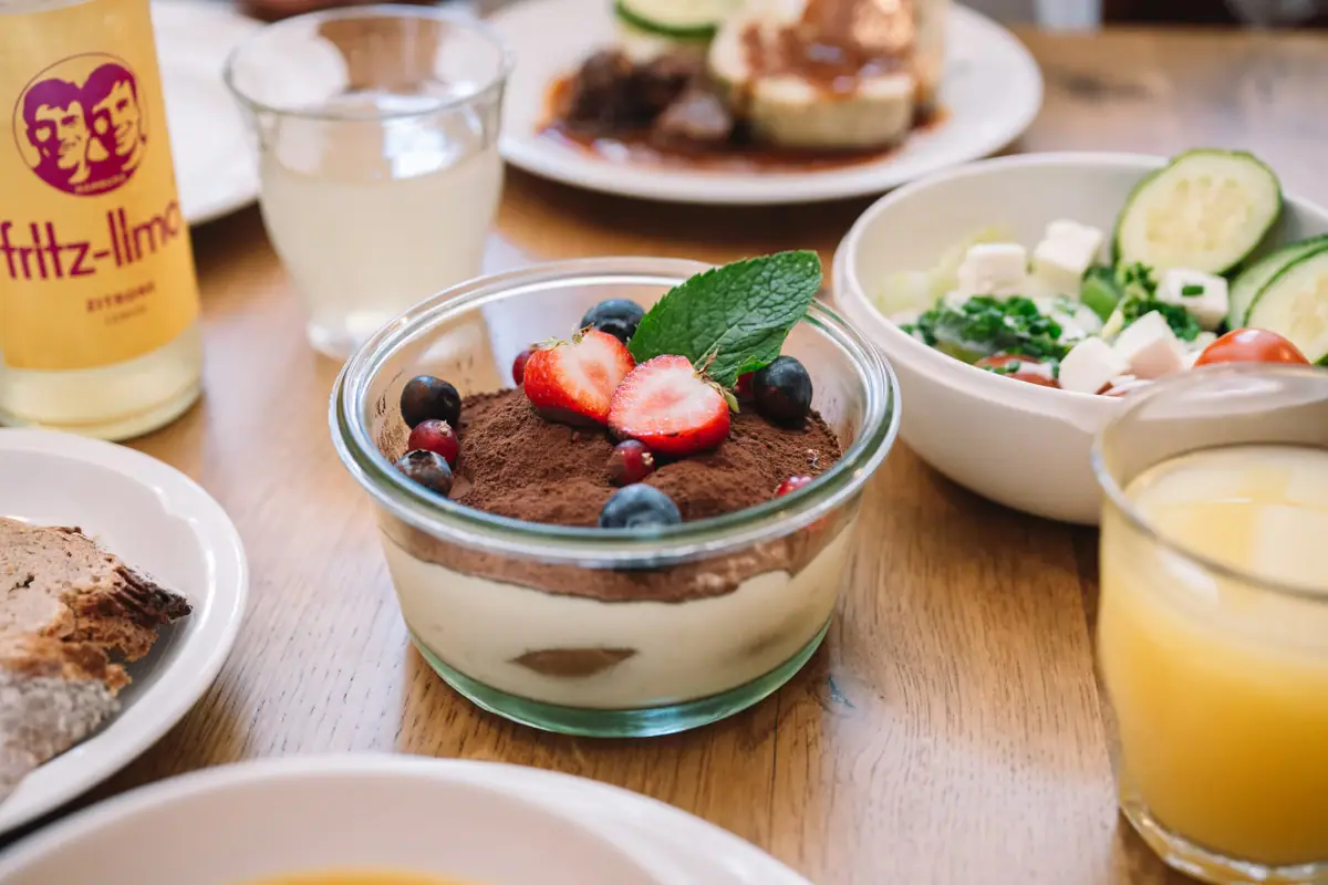 Dessert Bowl with dessert, garnished with strawberries and blueberries.