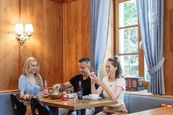 Klausner Stube in the HENRI Hotel Kitzbühel A group of people are sitting at a table.