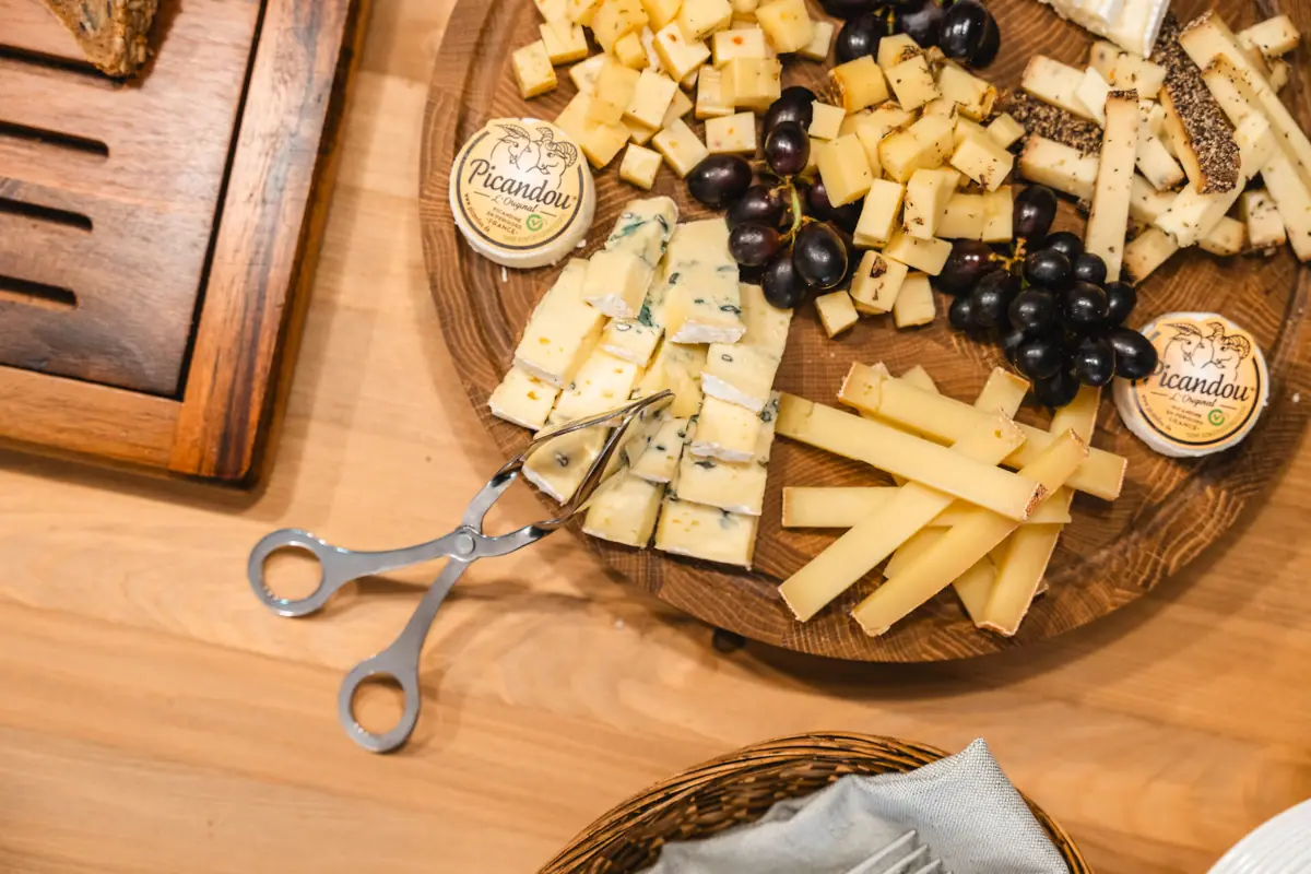 Cheese board A plate of cheese and grapes.