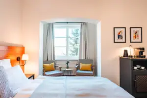 Bed Bedroom with bed and chairs, including bedside table and pillows.