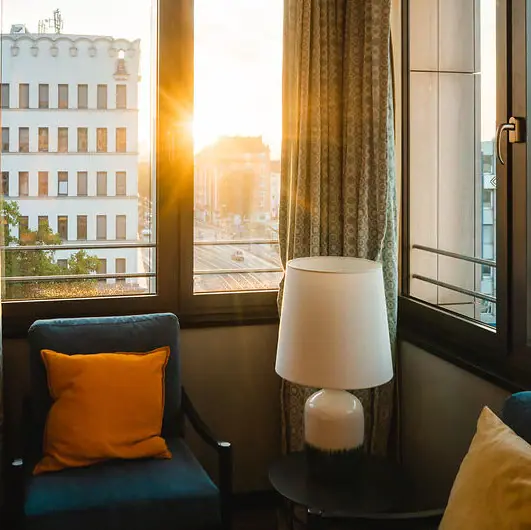 View A room with a lamp and a chair.