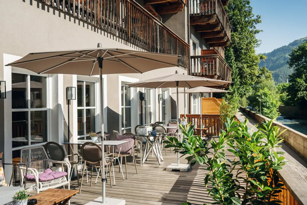 Terrace A terrace with chairs and parasols on a deck.