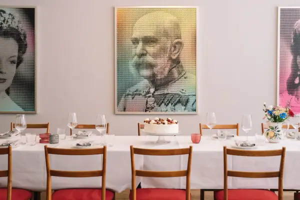 Salon Milano at the HENRI Hotel Kitzbühel A table with a cake and glasses on it.