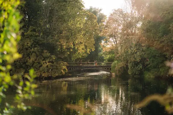 Park Bridge over a body of water with trees in autumn.