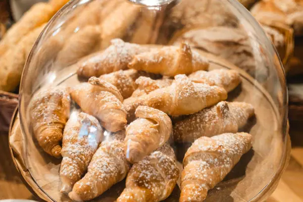 Croissants A plate of croissants dusted with icing sugar.