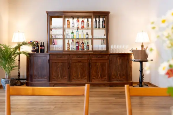 Ache Gallery 2 in the HENRI Hotel Kitzbühel A house bar with glasses and bottles on top.