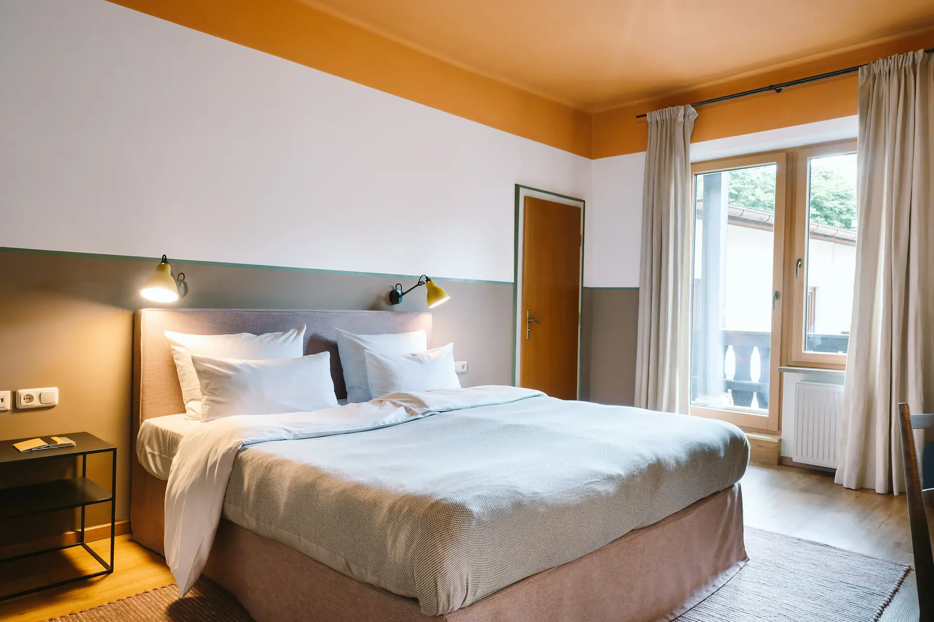 Hotel rooms at the HENRI Hotel Garmisch-Partenkirchen A bed in a hotel room at the HENRI Hotel Garmisch-Partenkirchen with a stylish interior.