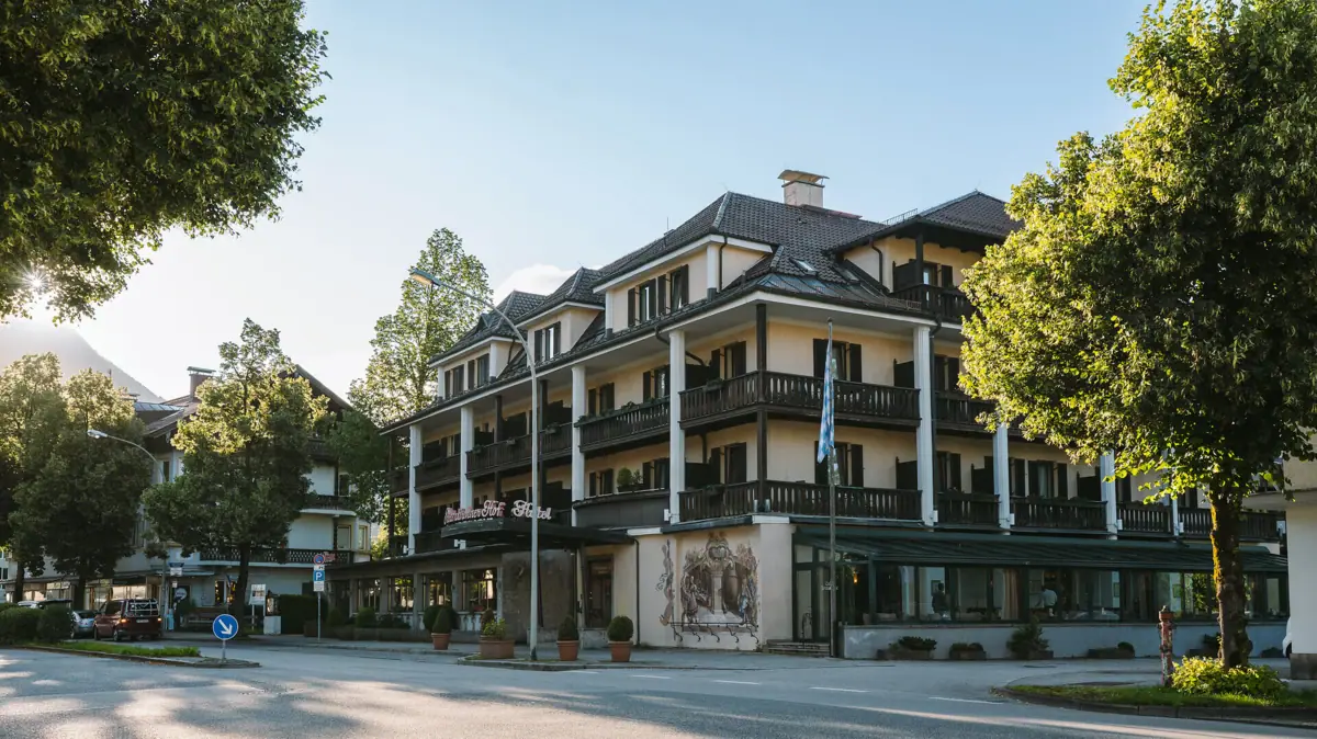 HENRI Hotel Garmisch-Partenkirchen Exterior view The exterior view of the HENRI Hotel Garmisch-Partenkirchen surrounded by trees.