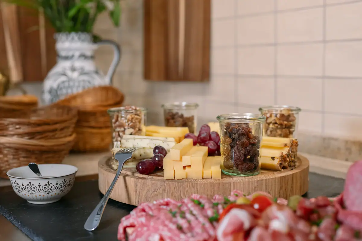 Sausage and cheese platters Cheese and nuts on a wooden board