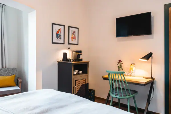 Coffee and tea station A room with a bed, desk and television.