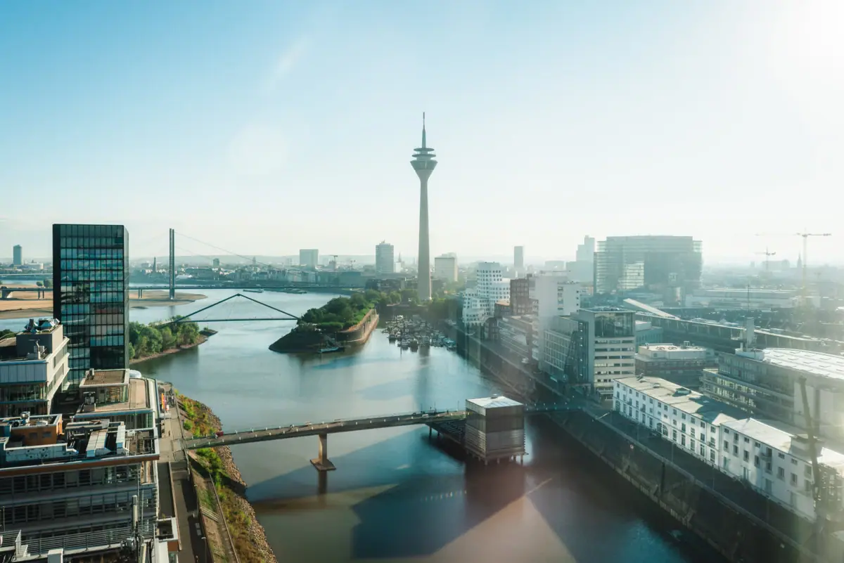Düsseldorf River with bridge and town in the background, dominated by a tower.