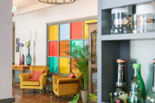 Lobby A room with a chandelier and chairs.