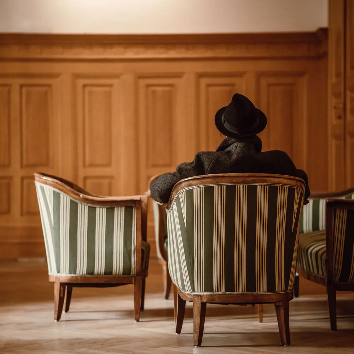 HENRI in Vienna A man sits on a chair.