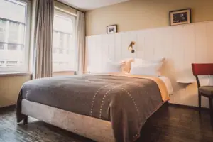 Bed Bed with lamp and window in a stylish hotel room.