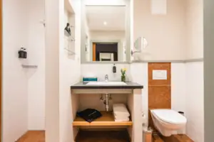 Bathroom Bathroom with washbasin and toilet, equipped with mirror and fittings.