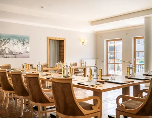 Meeting room at the HENRI Hotel Kitzbühel A room with tables and chairs.