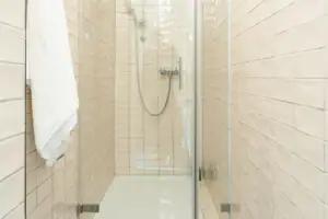 Bathroom HENRI Kitzbühel Shower with glass door and tiles.