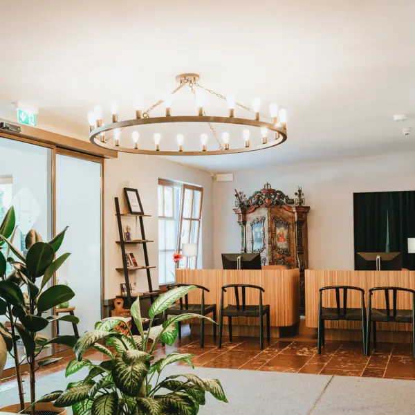 Reception A room with a chandelier and chairs.