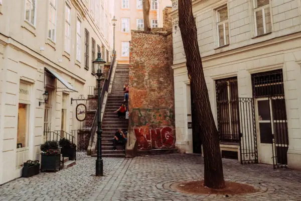 Vienna city centre A group of people walk down a flight of stairs in an inner courtyard.