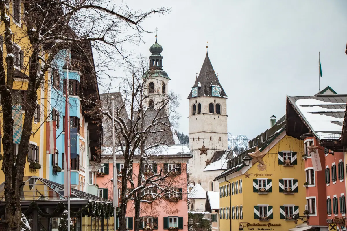 Kitzbühel city centre A group of buildings with snow on the roofs.